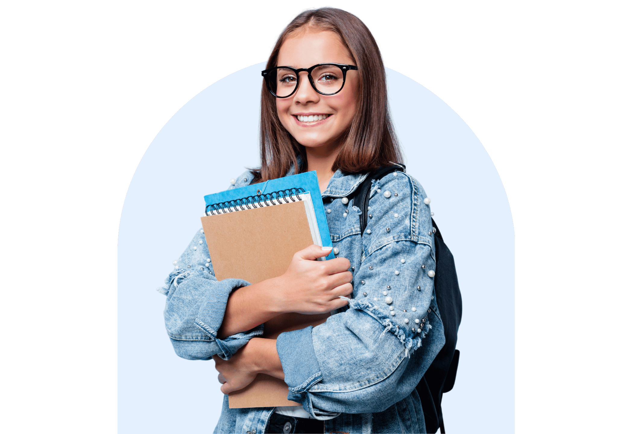 Smiling secondary student wearing glasses and a denim jacket, holding school notebooks against a light blue background